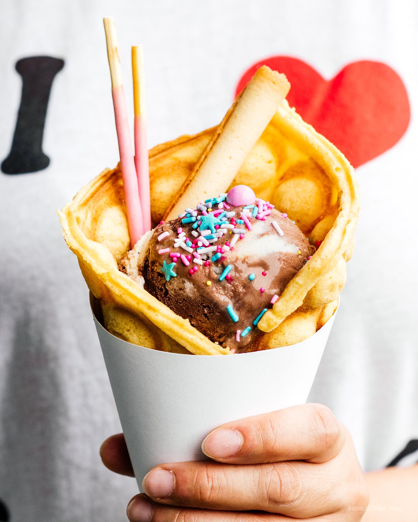 Make your own infinitely instagram friendly bubble waffle ice cream cones/puffle cones/eggloo egg waffle cones right at home. The batter comes together easily and you can fill your cones with ALL the things: ice cream, fruit, cookies, anything goes. #bubblewaffle #bubblewafflecones #hongkongbubblewaffles #pufflecone #eggloo #eggwaffle #recipes #dessertrecipes