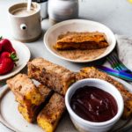 This is going to be the best French toast you’ll ever eat! Cure your churro and French toast cravings with these golden brown crispy French toast sticks dipped in cinnamon and sugar. Dark chocolate dipping sauce not optional! #breakfast #brunch #recipes #frenchtoast #churros #cinnamonsugar #frenchtoaststicks