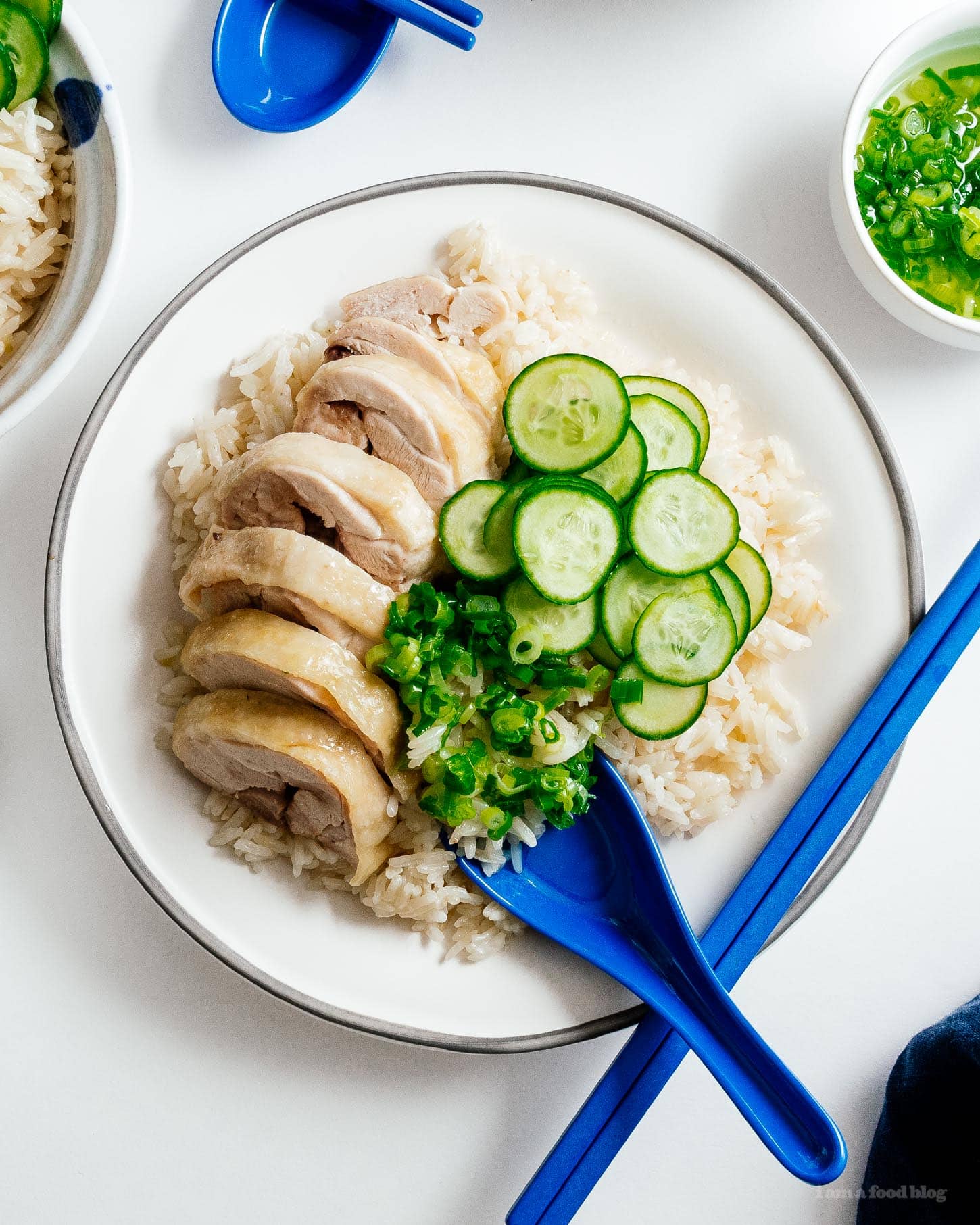 Super simple and satisfying Hainanese chicken rice: juicy steamed chicken and ginger garlic rice cooked in the same pot. It’s what you want for dinner, right now! #hainanesechickenrice #chickenrice #recipes #dinner #onepot #easy #chickenrecipe #rice #chickenandrice
