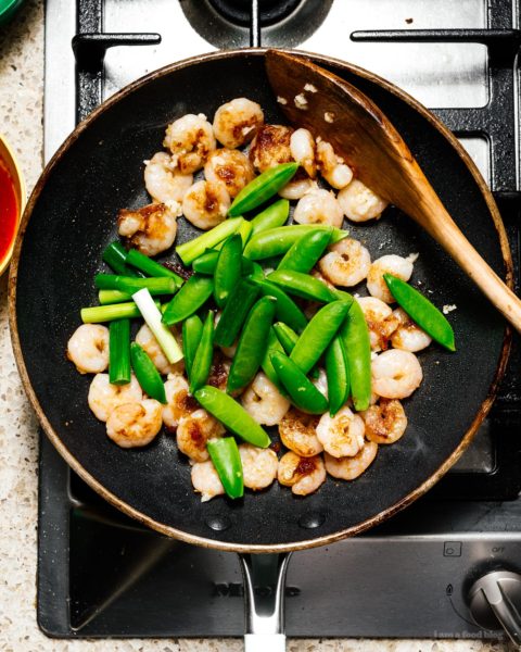 Shrimp and snap pea stir fry: a glossy, spicy, all-in-one protein and veggie dish that is just the perfect thing to make for a quick weeknight dinner. #stirfry #dinner #shrimp #snappeas