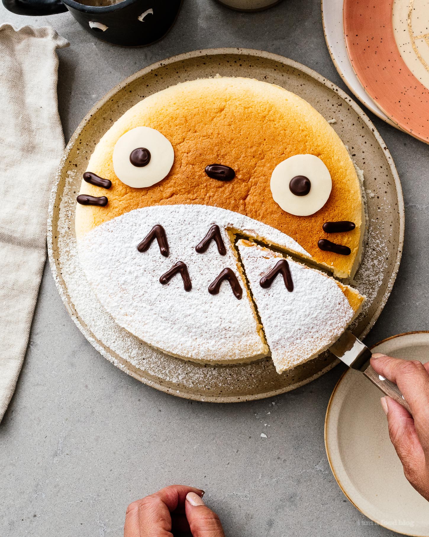 A super cute fluffy, jiggly Totoro cheesecake: pillowy soft, cotton-y, light-as-air cheesecake with just a hint of sweetness. #cheesecake #japanesecheesecake #fluffycheesecake #totorocake #totorocheesecake #totorofood #kawaiifood