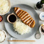 Easy oven baked pork tonkatsu: An extra thick, super juicy pork chop done up tonkatsu style, with light and crispy panko, only baked instead of deep-fried. #japanesefood #japanese #tonkatsu #porkchop #pork #recipes #ovenbaked #dinner #easydinner