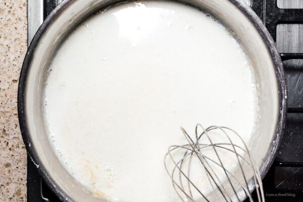 combining milk and roux to make a bechemel | www.iamafoodblog.com