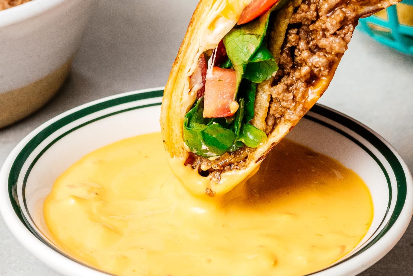 crunchwrap dipped in queso | www.iamafoodblog.com